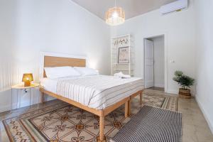 a bedroom with a large bed in a room at BISCOTTAI Port Apartments in Trapani