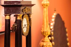 a clock is sitting next to two other clocks at Dear Lisbon - Palace Chiado Suites in Lisbon