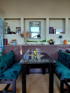 a table and two chairs in a room at DENY INN Funland in Zărneşti