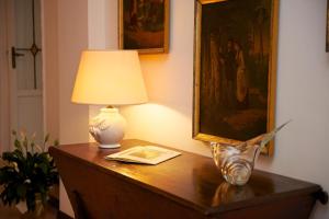 a table with a lamp and a book on it at Romantic Hotel & Restaurant Villa Cheta Elite in Maratea