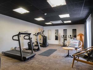 a gym with treadmills and exercise equipment in a room at ibis Montauban in Montauban