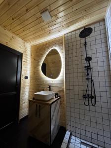 a bathroom with a sink and a mirror at kesis chalet in Borjomi +16 photos