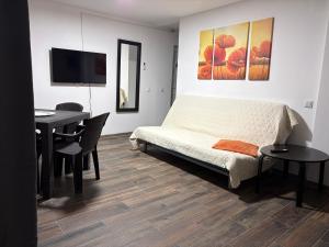 a bedroom with a bed and a desk and a table at Geo Saturn in Saturn