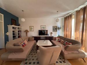 a living room with a couch and chairs and a table at Home Medicci in Bihać