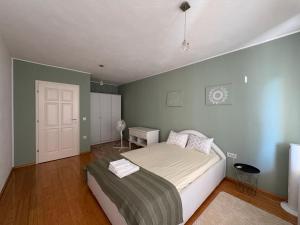 a bedroom with a large bed and a white door at Home Medicci in Bihać