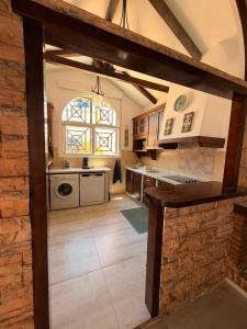a large kitchen with a counter and a window at Villa Wilecris in Punta Umbría +22 photos