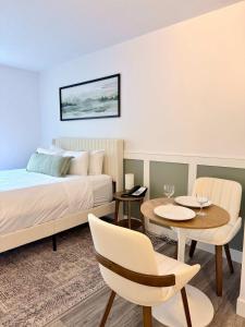 a bedroom with a bed and a table and chairs at Cascade Lodge Studio-steps from village in Whistler +17 photos