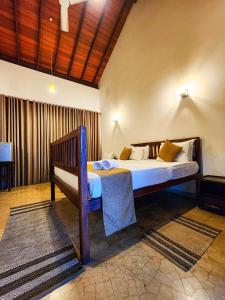 a bedroom with a bed and a bench in a room at New Moonstone Tangalle in Tangalle +25 photos