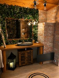 a bathroom with a sink and a brick wall at Cityside Cottage in Eger