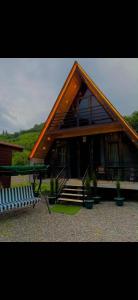 una grande casa con due panchine davanti di Machakhela Hills a Machakhlispiri