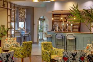 a bar in a restaurant with colorful chairs at Best Western Plus Nottingham Westminster Hotel in Nottingham