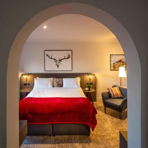 a hotel room with a bed and a chair at JA The Bruntsfield - Edinburgh in Edinburgh