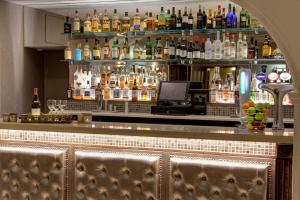 a bar with a lot of bottles of alcohol at Best Western Plus Dunfermline Crossford Keavil House Hotel in Dunfermline
