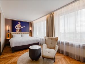 a hotel room with a bed and a chair at Radisson Blu Hotel & Spa, Daugava Riga in Riga