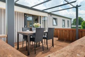 a deck with a table and chairs on a house at Peter Pan in Dörverden