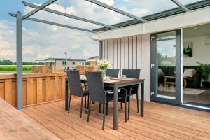 a patio with a table and chairs on a deck at Peter Pan in Dörverden