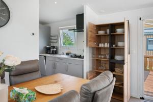 a kitchen with a wooden table and chairs and a dining room at Peter Pan in Dörverden +17 photos