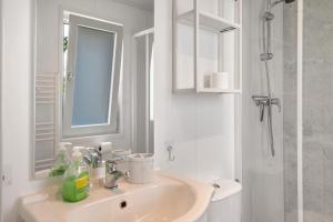a white bathroom with a sink and a shower at Peter Pan in Dörverden