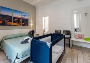 a bedroom with a blue bed and a table at Moon Bologna in Bologna