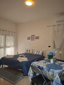 a bedroom with two beds and two tables in it at Costa Marina in Marsala