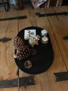 a black table with pine cones and candles on it at Rom med eget bad til leie felles inngang Uten kjøkken og stue Kun overnatting in Tjørhom
