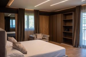 a bedroom with a bed and a chair in it at Tre Fontane Country House in Sperlonga