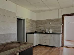 an empty kitchen with a counter in a room at Viesu nams Kātiņi in Energetikis +16 photos