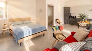 a bedroom with a bed and a red couch at Casa Quadrifoglio - Valgrande in Intra +11 photos