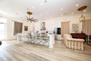 a kitchen and living room with a bar and a dining room at Blue Crawfish Boutique Hotel & Pool Bar in New Orleans