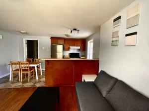 a living room and kitchen with a couch and a table at Aldergrove 2 in St. John's