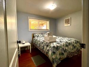 a bedroom with a bed with towels on it at Aldergrove 2 in St. John's