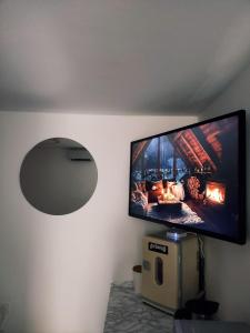 a flat screen tv hanging on a wall at Chambre d'hôte à Wiltz in Wiltz