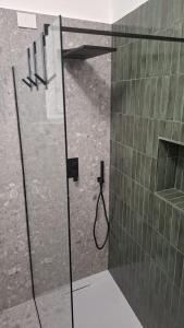 a shower with a glass door in a bathroom at Mansio Pegaso in Tivoli