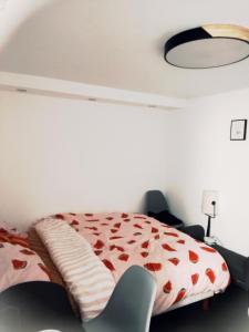 a bedroom with a bed and a chair at Chambre d'hôte à Wiltz in Wiltz