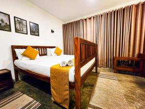 a hotel room with a bed and a table at New Moonstone Tangalle in Tangalle