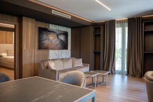a living room with a couch and a table at Tre Fontane Country House in Sperlonga