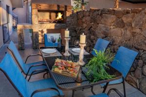 a table with a tray of fruit and candles on it at Grateus Apart in Villa General Belgrano