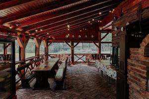 a room with tables and chairs in a building at Hanul Morii in Ciucea