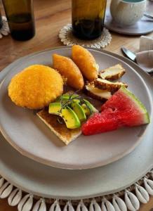 a plate of food with bread and fruit on it at Pirita Beach House in Santa Ana +43 photos