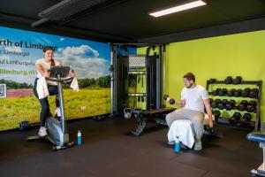 two men and a woman in a gym at Work and Stay in Maasbree