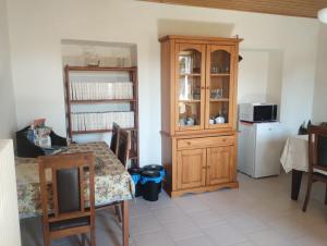 a kitchen with a table and a wooden cabinet at BeB LORTALLINO in Ameno