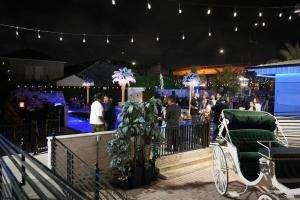 a crowd of people at a party at night at Blue Crawfish Boutique Hotel & Pool Bar in New Orleans +30 photos
