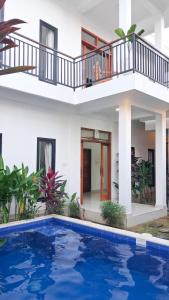 a villa with a swimming pool in front of a house at Rumah Merta Sari in Bingin Beach +13 photos