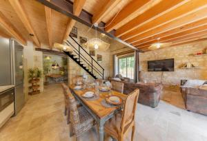 a dining room with a table and some chairs at La Châtellerie du Gagnon in Champagnolles