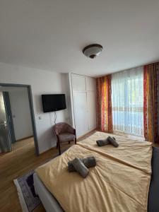 a bedroom with a large bed with two pillows on it at Guesthouse Mother in Sielach