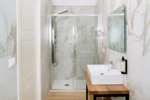 a white bathroom with a shower and a sink at B&B Da Anna in Torretta +82 photos