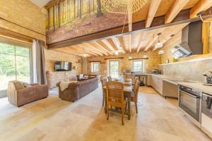 a kitchen and living room with a table and chairs at La Châtellerie du Gagnon in Champagnolles