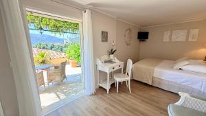 a bedroom with a bed and a table and a window at Villa Kilauea B&B in Nice +42 photos