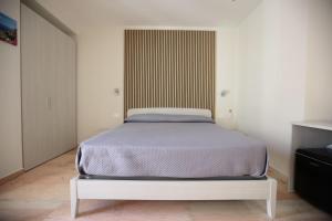 a bed in a white room with at Dimora del mare in Agropoli