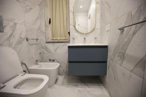 a bathroom with a toilet and a sink and a mirror at Dimora del mare in Agropoli +17 photos